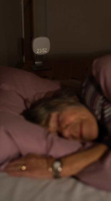 Sleeping woman using Somnofy at home